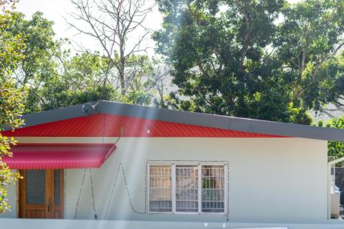 a small white house with a red roof at Francis Nook St Joseph Room in San Juan