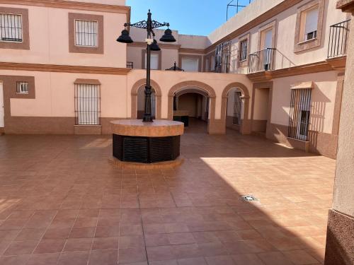an empty courtyard with a light in the middle of a building at Sevilla. Gerena Casa Rural para familia o profesionales in Gerena