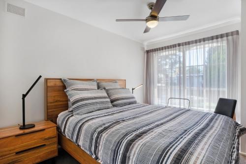 a bedroom with a bed and a ceiling fan at Becca's on Burke in Bright