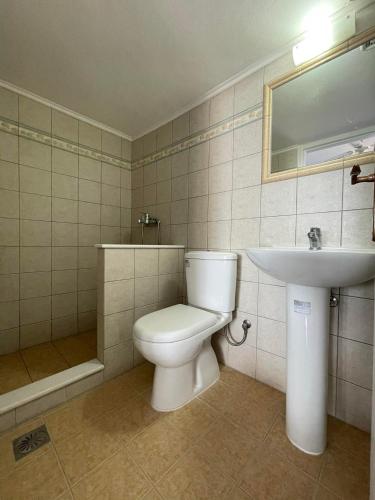 a bathroom with a toilet and a sink at Argo Studios in Myrties