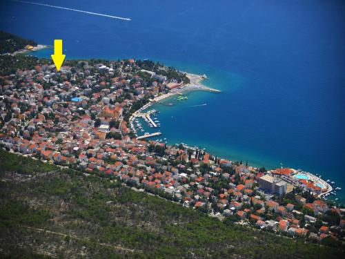 an aerial view of an island with a yellow arrow at Apartments Marija in Selce
