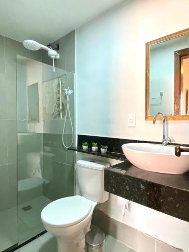 a bathroom with a toilet and a sink at Casa 105 in Arraial do Cabo