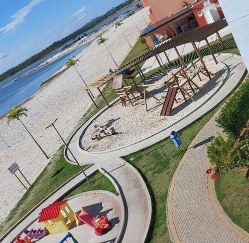 an aerial view of a playground next to the beach at Resort GoldenLake em Arraial do Cabo in Arraial do Cabo