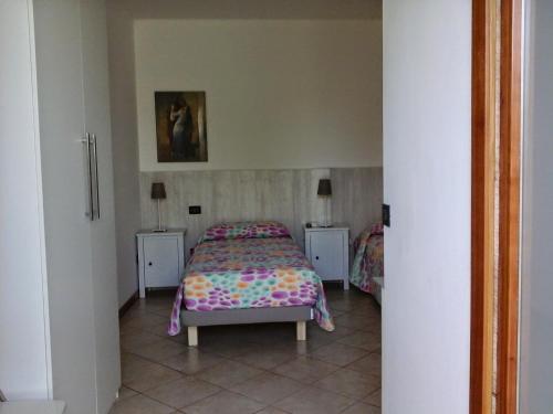 a bedroom with a bed and two night stands at La Casa di Linda in Mirano
