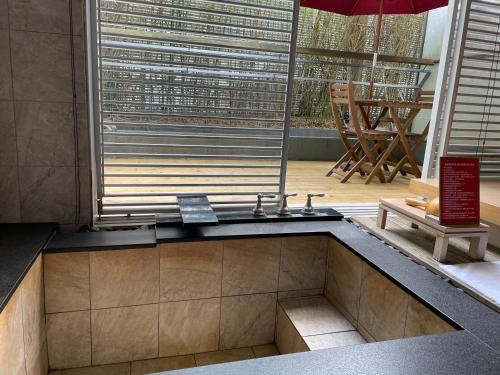 a room with a sauna with a table and an umbrella at Hotel Double One in Taipei