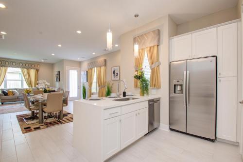 a kitchen with a refrigerator and a dining room at Elegant East Downtown House Houston TX in Houston