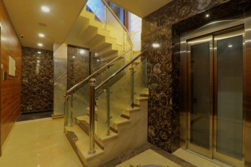a staircase in a house with a glass railing at Shri Tirupati Residency in Nilmatha