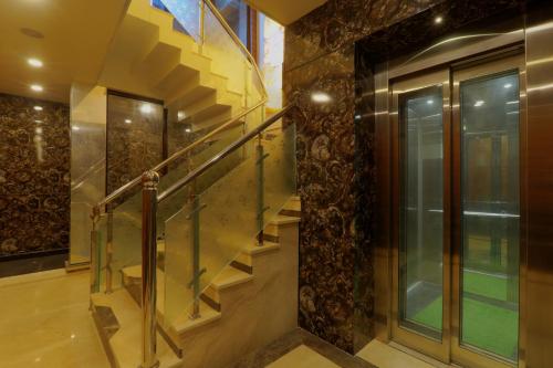 a staircase in a house with a glass railing at Shri Tirupati Residency in Nilmatha