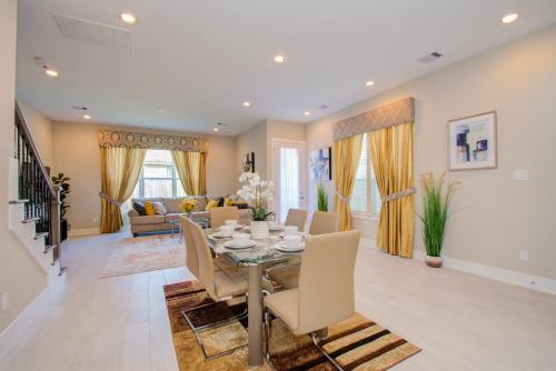 a dining room and living room with a table and chairs at Elegant East Downtown House Houston TX in Houston