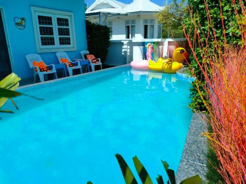 a swimming pool with a pool noodle toy in front of a house at 350m to beach pool villa in Hua Hin