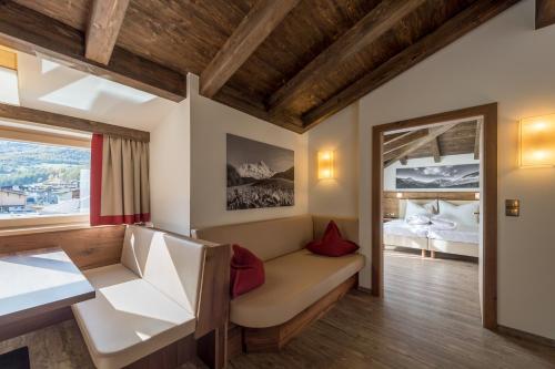 Pokój z kanapą, łóżkiem i oknem w obiekcie The Lodge by Regina w Solden