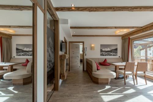 a restaurant with tables and chairs and a window at The Lodge by Regina in Sölden