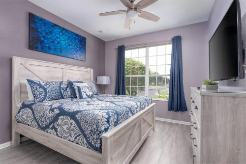 a bedroom with a bed and a tv and a window at Spacious 4BR Home Themed Rooms, Pool, Near Disney in Orlando