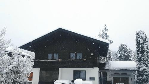 a house with snow on the roof of it at Apartment Steirawohnzimmer in Haus im Ennstal