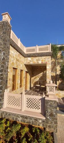 a large stone building with a porch and a patio at Vikrama Heritage Resort Pavagadh in Hālol