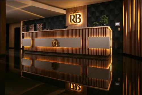 a lobby with a reflection in the water of a building at Reghina Blue Hotel in Timişoara