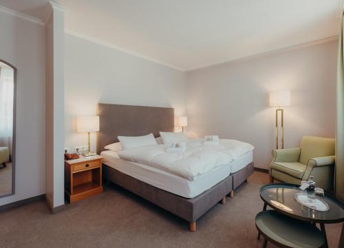 Postel nebo postele na pokoji v ubytování Hotel Jungclaus