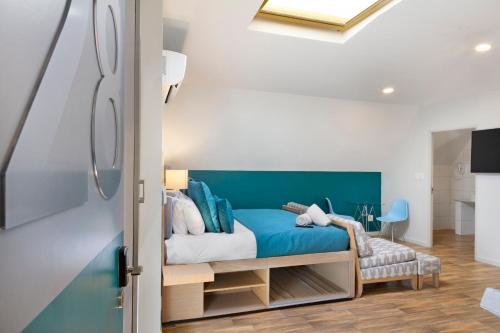a bedroom with a bed with a blue headboard at Urban Oasis Aparthotel in Cape Town