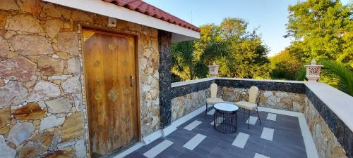 a stone house with a wooden door and a patio at Vikrama Heritage Resort Pavagadh in Hālol