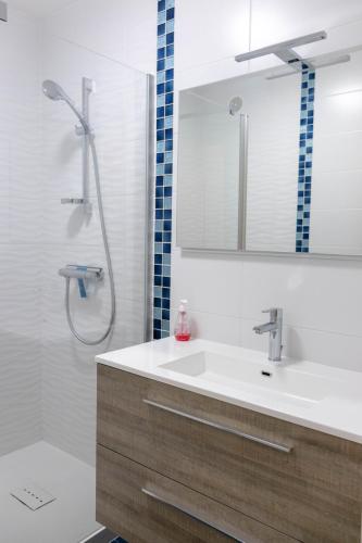 une salle de bain avec un lavabo et une douche avec un miroir dans l'établissement Appartement sur Port - 78m2 Balcon, à Saint-Gilles-Croix-de-Vie