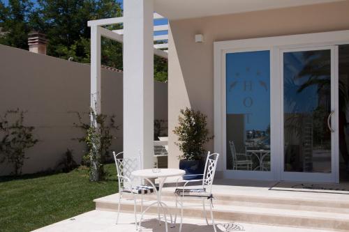 a patio with a table and chairs in front of a house at Hotel Nautilus in Cagliari