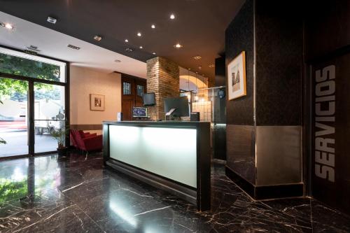 a large flat screen tv in a lobby at Petit Palace Ruzafa in Valencia