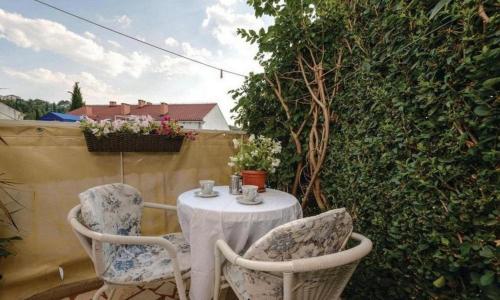 a table and two chairs sitting on a patio at Apartments Raguz in Cavtat