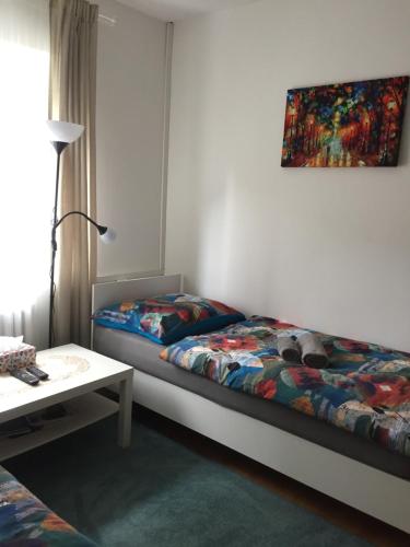 a bedroom with two beds and a dog laying on the bed at Ubytování Mája in Liberec