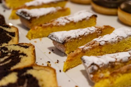 a bunch of pastries with powdered sugar on them at Petit Palace Ruzafa in Valencia