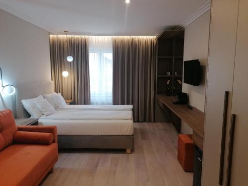 a hotel room with a bed and a couch at Casa La Fayette in Timişoara