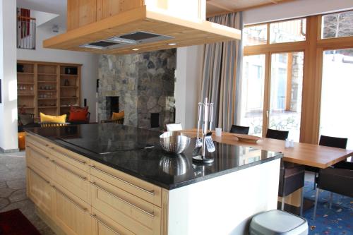 a kitchen with a large island with a black counter top at ClubHotel Hinterthal Am FlorySee 12 in Hinterthal