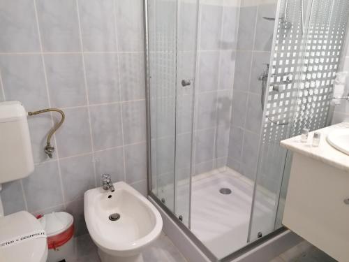 a bathroom with a shower and a toilet and a sink at Casa La Fayette in Timişoara