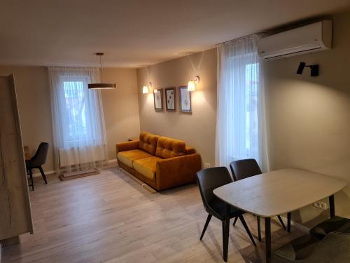 a living room with a couch and a table and chairs at Casa La Fayette in Timişoara