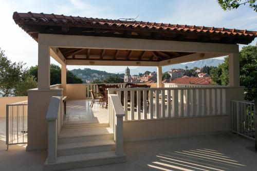 a gazebo on the roof of a house at Apartments Miljan Popovic in Cavtat