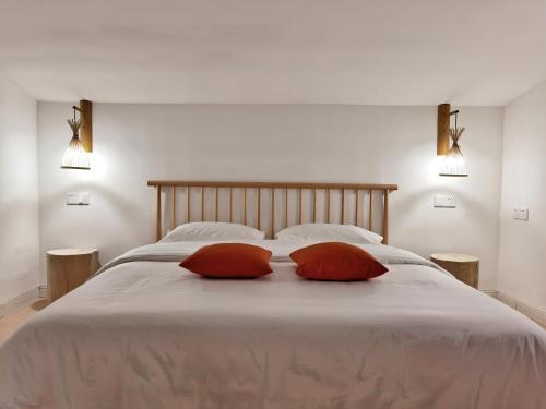 a bedroom with a large bed with two pillows on it at Riverside Retreat Hotel in Yangshuo