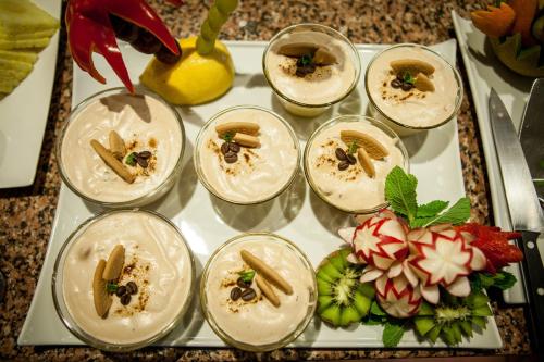 a tray with several dessert dishes on a table at Villa Rosa in Lagos