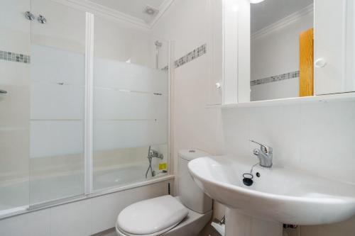 a bathroom with a sink and a toilet and a shower at HE DORIS in Orihuela Costa
