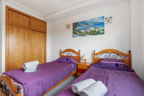 two beds sitting next to each other in a bedroom at HE DORIS in Orihuela Costa