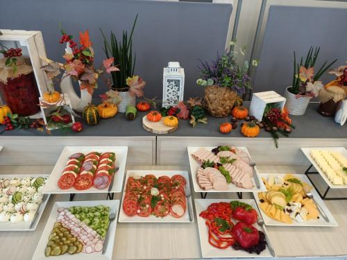 a table with many different types of food on it at Alabaster Rezydencja in Rzeszów