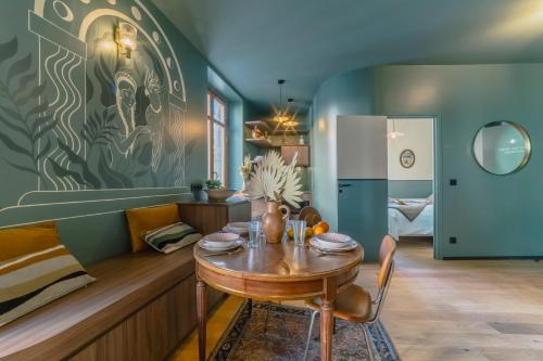 a dining room with a table and a refrigerator at Papagayo, appartement halles et côte des basques in Biarritz