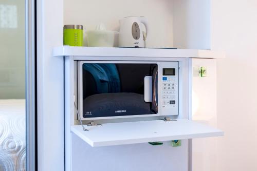a microwave oven in a white wall at ToMaDi Residence in Split