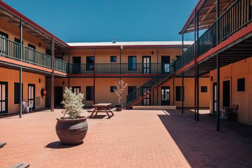 a courtyard of a building with a potted plant at Settlers Hotel York in York