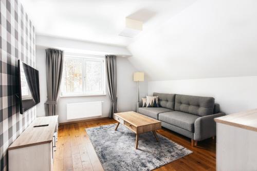 a living room with a couch and a table at Stacja Szklarska Poręba - cisza i komfort in Szklarska Poręba