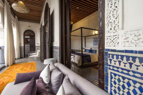 a hotel room with a bed and a bedroom at Riad Braya in Fès