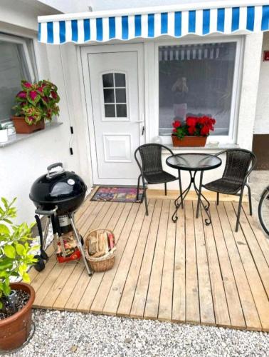 a patio with a bbq and a table and a grill at Apartments Karin in Bled