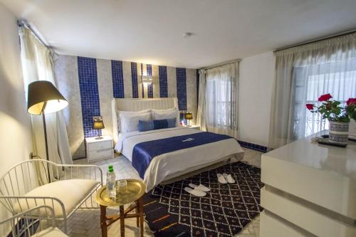 a hotel room with a bed and a table and chairs at Riad Braya in Fès