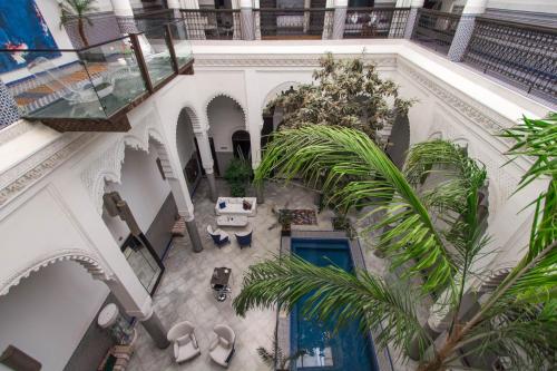 an overhead view of a building with a courtyard with palm trees at Riad Braya in Fès