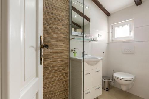 a bathroom with a toilet and a sink at ToMaDi Residence in Split
