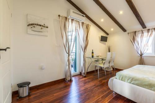 a bedroom with a bed and a table at ToMaDi Residence in Split