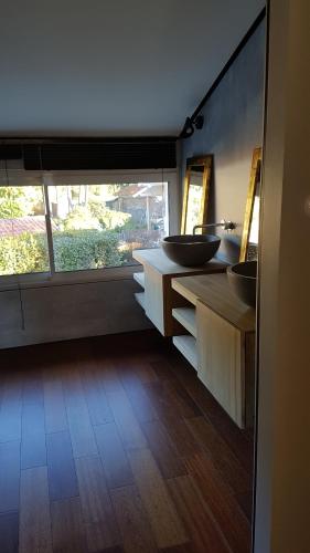 a bathroom with two sinks and a large window at Aux Sources d'Hossegor in Hossegor